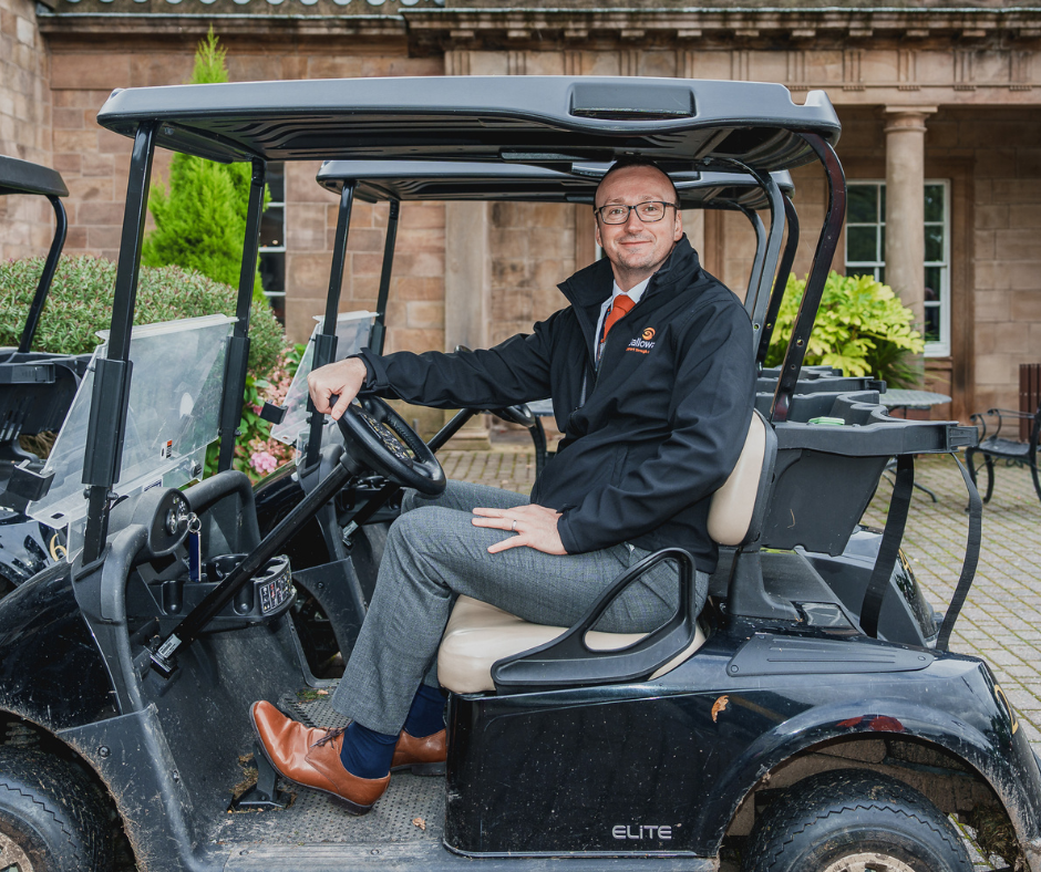 An image of our CEO on a golf buggy.
